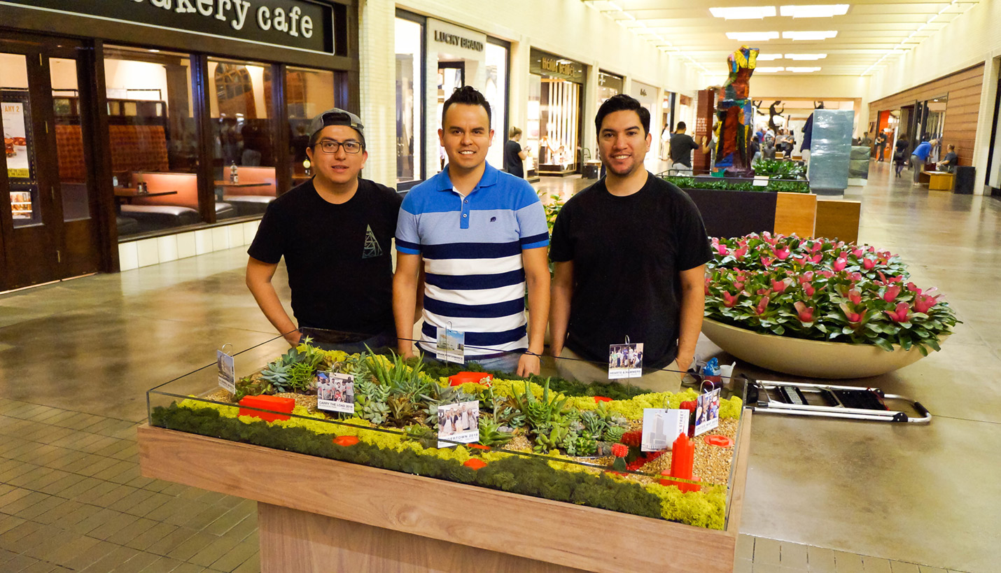 Proud Pagers Marco Martinez, left, Carlos Sierra and Eric Enriquez after installation of the Page display at the 2017 AIA Dallas RETROSPECT public exhibition. - Page