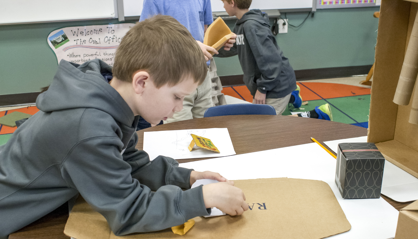 A Trinity Episcopal student considers the rotation of the center piece for his group's STEAMfest project. - Page