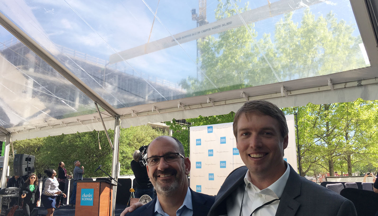 Page Principal Daniel Brooks and Associate Principal Matt Leach stand below the beam at the topping off ceremony. - 