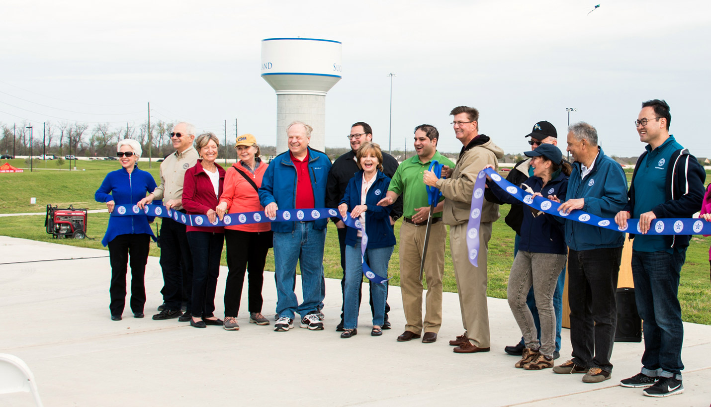 The City of Sugar Land PARCS Board helps the mayor (center, with ceremonial scissors) "cut the ribbon" on a new park. Board member and Pager Andy Phan is at the far right. - Andy Phan, Page Director of Visualization