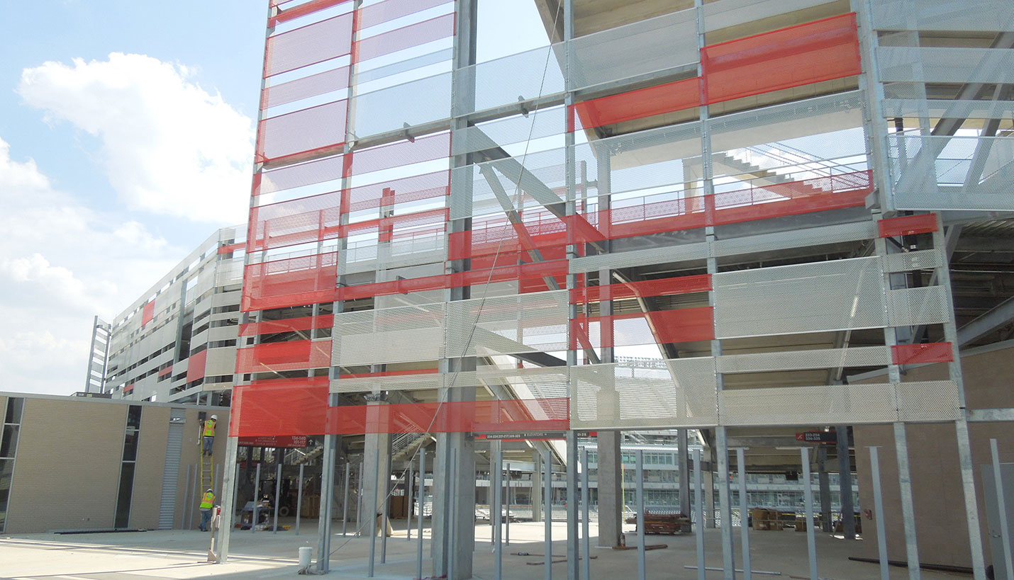 Keeping Houston Red: Gray and red panels on the exterior cage of the stadium become solid red to define the edges of the four entrances. (08/18/2014) - Page